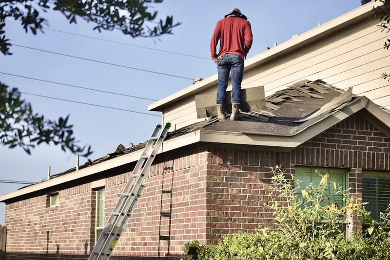 Professional roofer working on a residential roof in Patio Springs